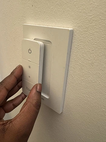 Side view of magnetic Philips Hue remote outside its white base