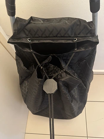 The black personal shopping trolley fastened with black string